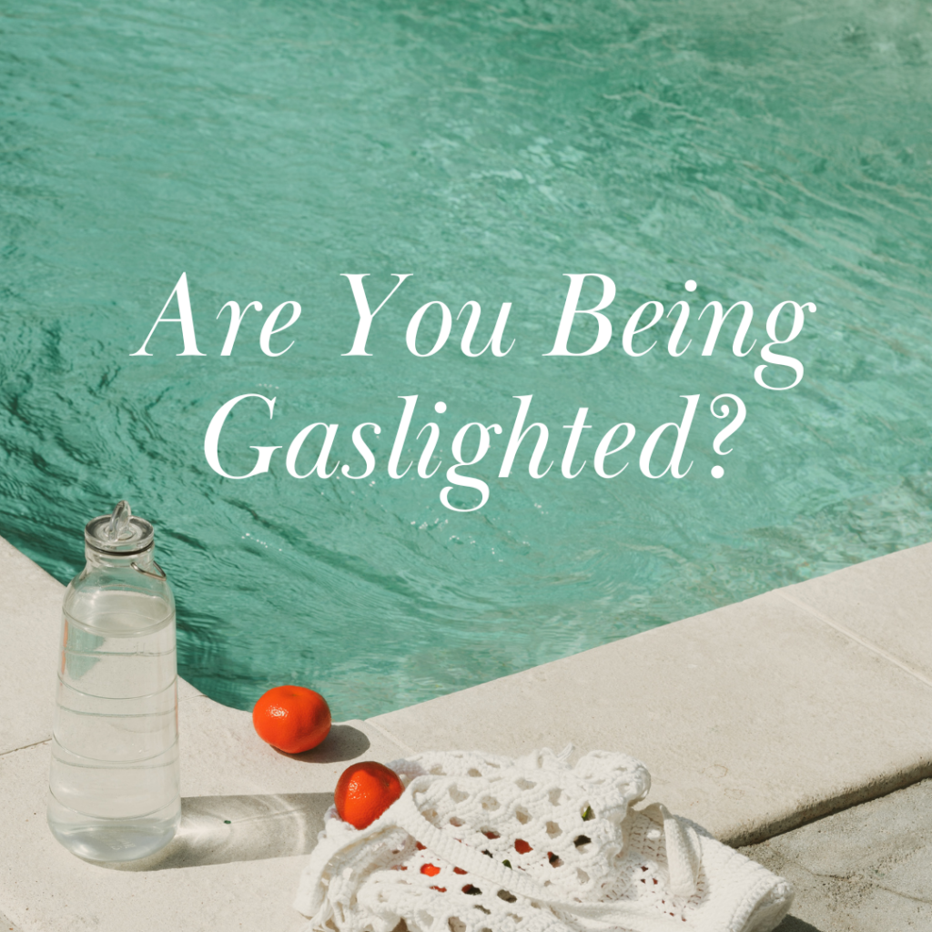 Are They Gaslighting You? Signs You Shouldn’t Ignore 1 A poolside scene with a clear water bottle, two small oranges, and a white net bag on a stone surface. The question "are they gaslighting you? " is overlaid on the image, set against the backdrop of glistening green water.